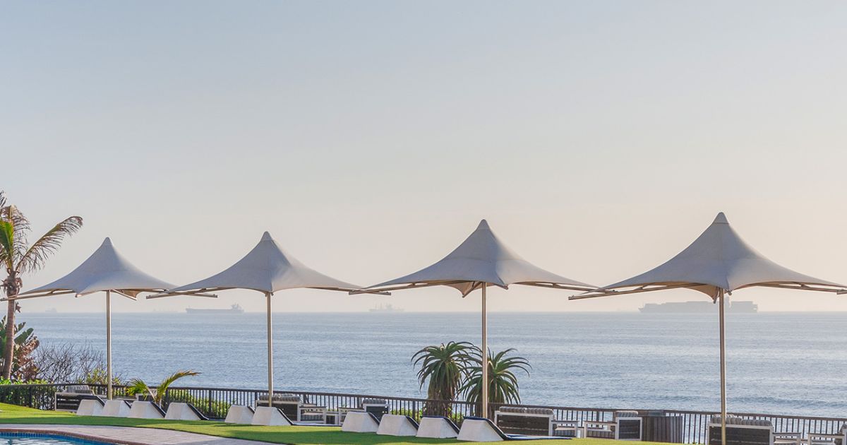 Poolside umbrellas and lawn at uMhlanga Sands Resort overlooking the Indian Ocean